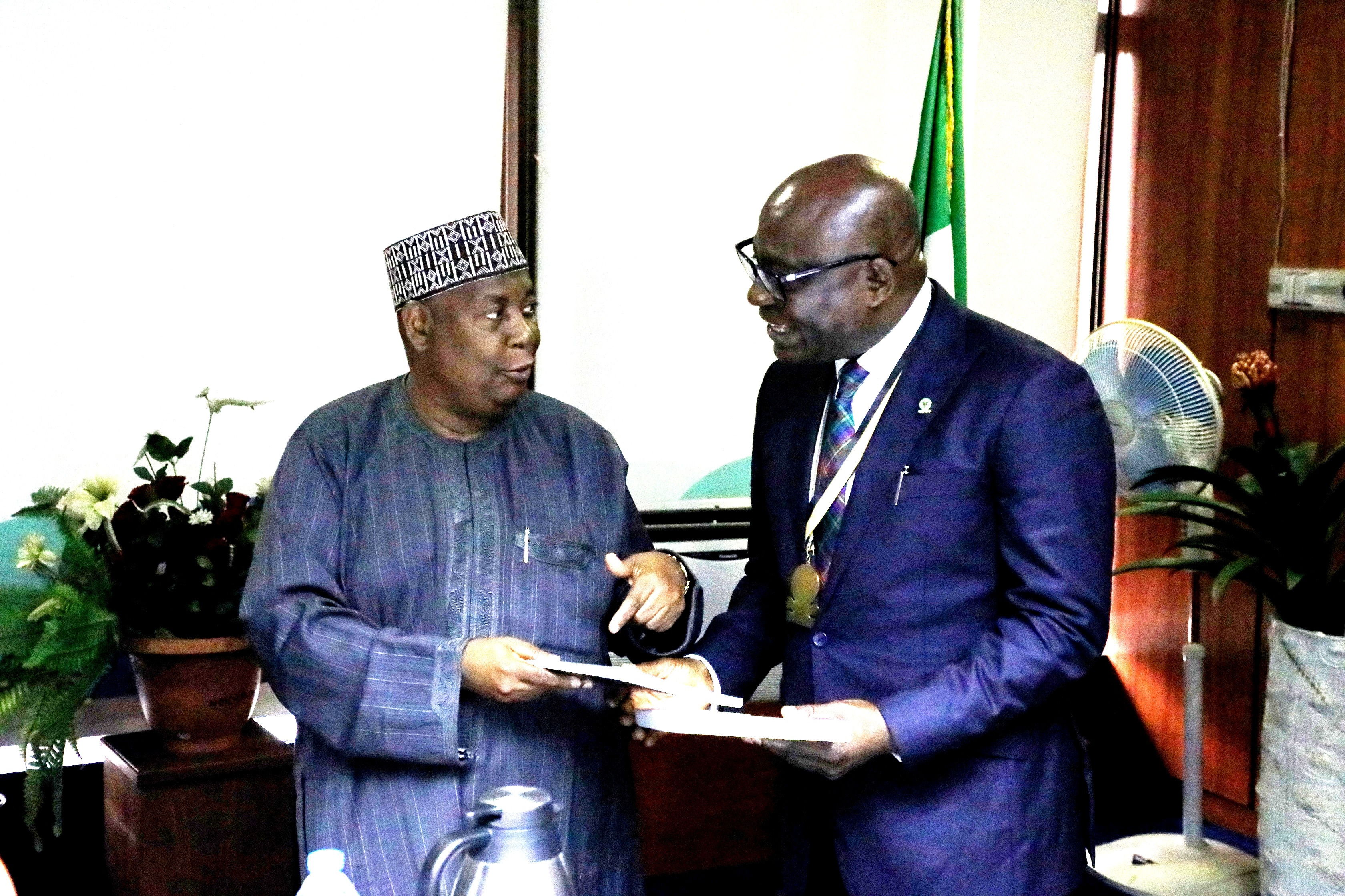 L-R: Nigeria Deposit Insurance Corporation (NDIC) MD/CE, Umaru Ibrahim, presents the Corporation’s research publications to the President and Chairman of Council, Chartered Institute of Bankers of Nigeria (CIBN), Dr. Uche Olowu during the Council’s courtesy visit to the NDIC Management at the Corporation’s Head Office, Abuja.