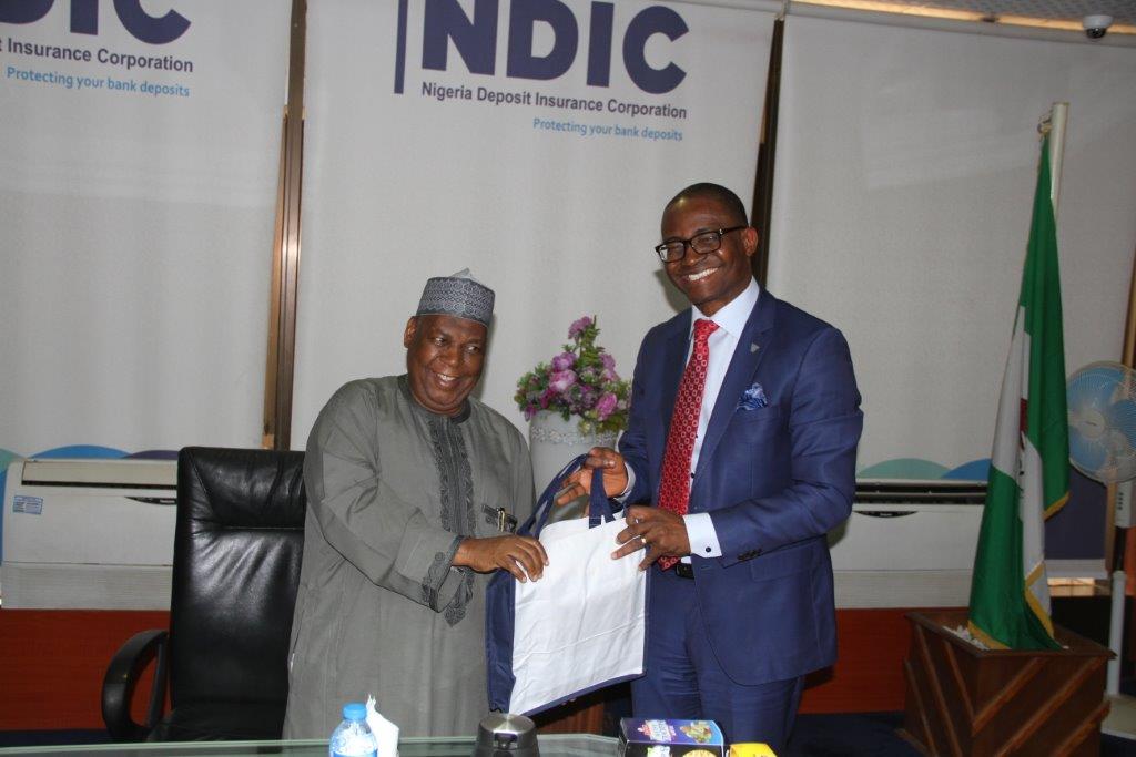 L-R: Nigeria Deposit Insurance Corporation (NDIC) MD/CEO Umaru Ibrahim presenting the Corporation’s publications to the  Wema Bank of Nigeria PLC, Managing Director Mr Ademola Adebise during a courtesy visit of the Wema Bank Executive Management to the Corporation`s Head Office in Abuja.