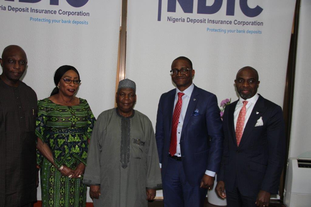 Nigeria Deposit Insurance Corporation (NDIC) MD/CEO Umaru Ibrahim (3rd left) poses for a group photograph with NDIC Executive Director Operations, Prince Aghatise Erediawa (1st left) and NDIC Executive Director Corporate Services, Hon. Omolola Abiola Edewor (2nd left). Alongside them are the Wema Bank of Nigeria PLC, Managing Director Mr Ademola Adebise and Deputy Managing Director, Moruf Oseni who led the Wema Bank management team on a courtesy visit to the Corporation`s Head Office in Abuja.