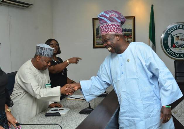 The MD/CE of the Nigeria Deposit Insurance Corporation (NDIC) Umaru Ibrahim (left) exchanges pleasantries with the Ogun State Governor, Ibikunle Amosun (right) during the NDIC Board’s visit to the Governor led by the NDIC Board Chairman, Ronke Sokefun (centre) as part of the Corporation’s Board Retreat in Abeokuta, Ogun State.